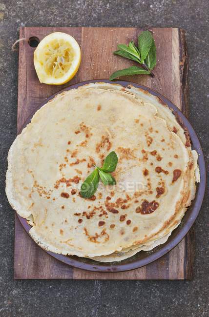 Stack of crepes with lemon — Stock Photo