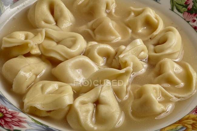Tortellini pasta in broth — Stock Photo