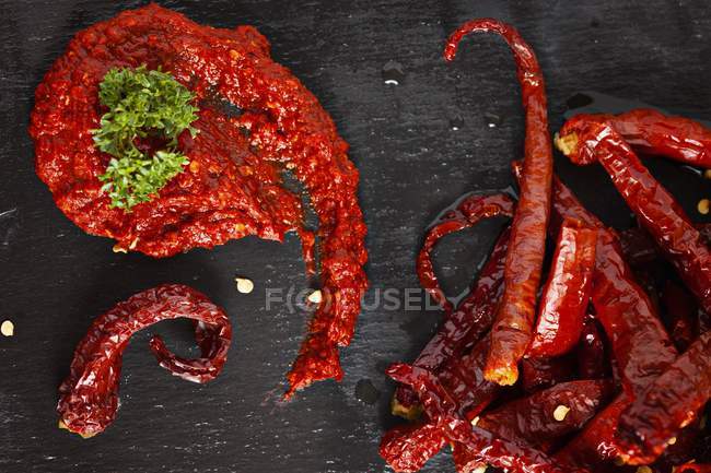 Chili paste and chili peppers — Stock Photo