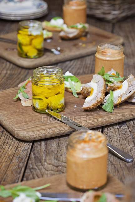 Elevated view of Scotch eggs on wooden chopping boards with sauces — Stock Photo