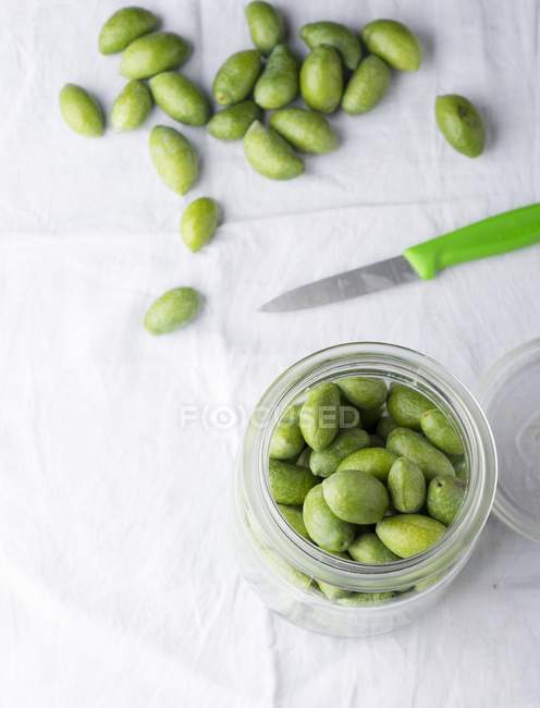 Fresh olives in preserving jar — Stock Photo