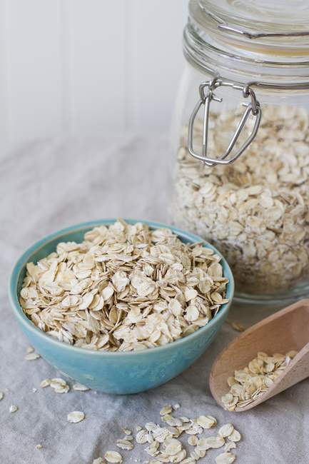 Closeup view of oats in a bowl and a jar — Stock Photo