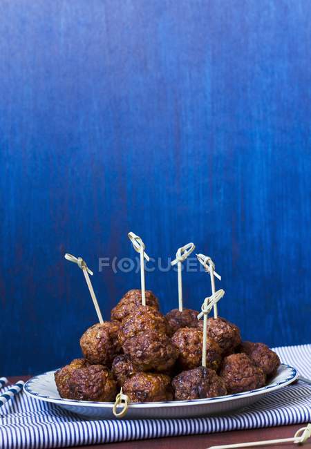 Meatballs on sticks on plate — Stock Photo