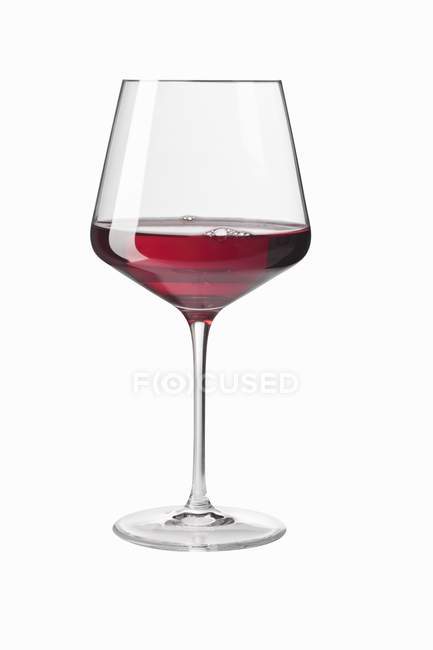 Closeup view of a glass of red wine on a white background — Stock Photo