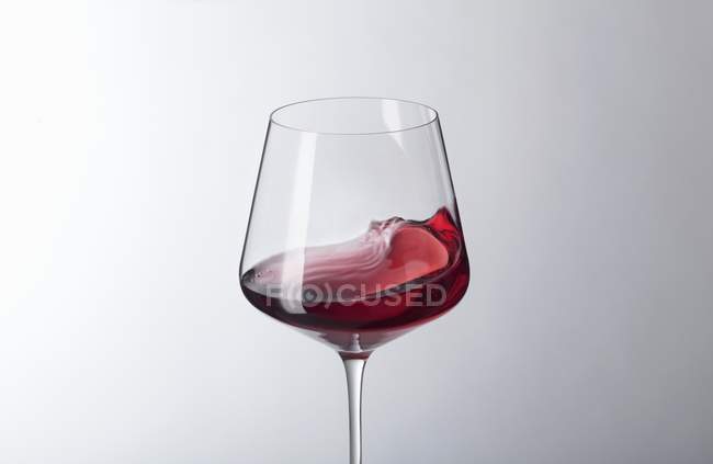 Red wine swilling in a glass — Stock Photo