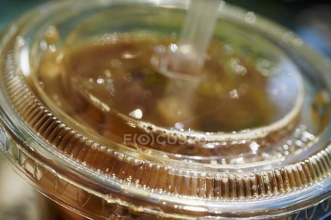 Closeup view of iced coffee in a plastic container — Stock Photo