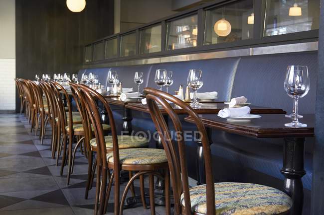 A long row of tables laid in a restaurant — Stock Photo