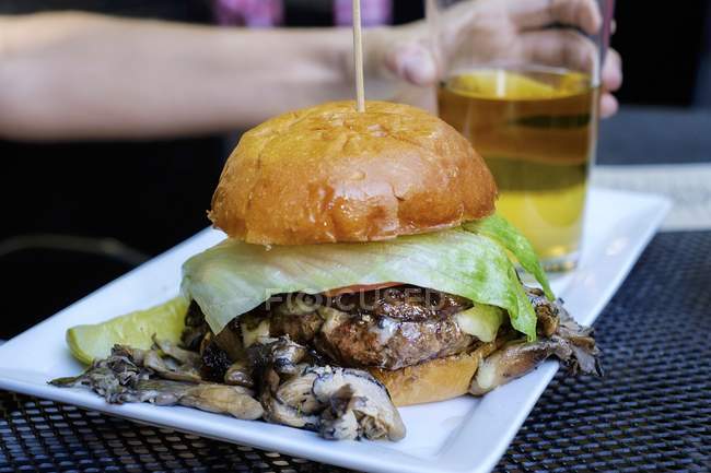 Mushroom burger and glass of beer — Stock Photo