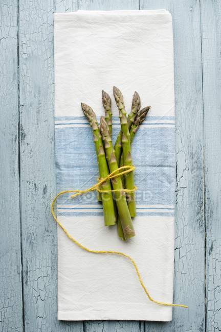 Bunch of tied green asparagus — Stock Photo