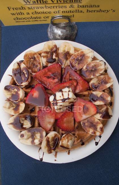 Waffles with strawberries on plate — Stock Photo