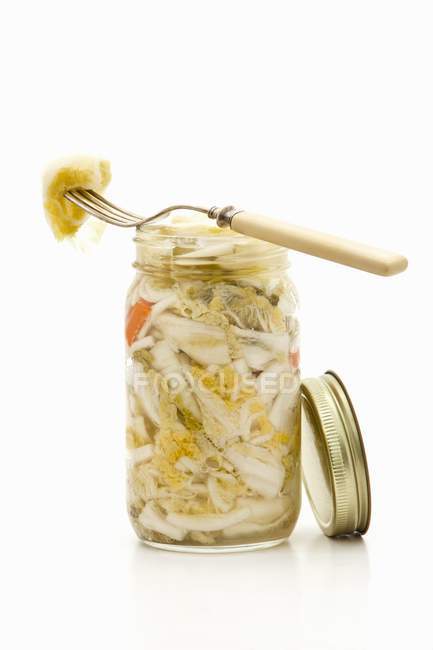 A jar of pickled bok choy on a white surface — Stock Photo