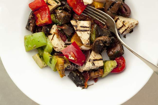 Antipasti with grilled tofu on white plate with fork — Stock Photo