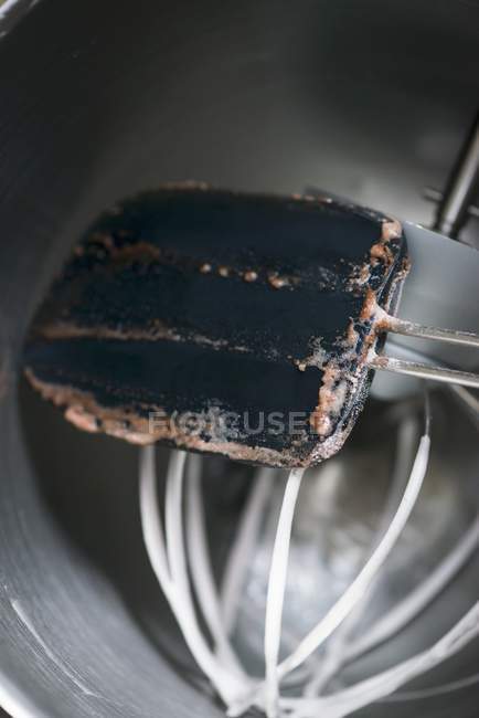Closeup view of used spatula and a whisk with cake remains — Stock Photo