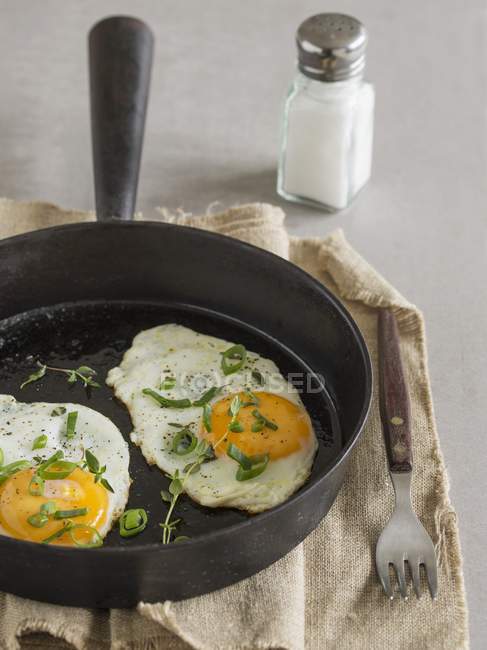 Fried eggs in frying pan — Stock Photo