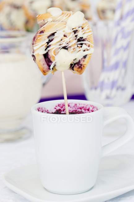 Closeup view of blueberry pastry on stick in white cup — Stock Photo