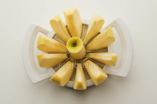 Fresh sliced apple in slicer — Stock Photo