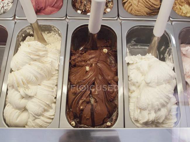 Various types of ice cream in metal containers — Stock Photo