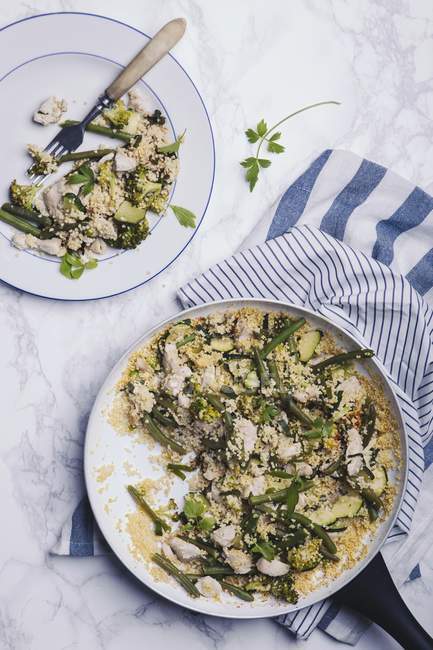 Hirseeintopf mit Huhn und Gemüse auf weißem Teller und im Teller — Stockfoto