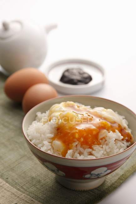 Boiled rice with raw egg — Stock Photo