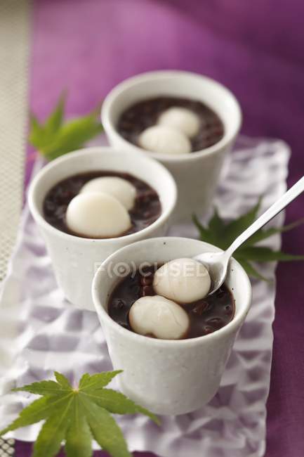 Zenzai kidney bean soup with wasashi in white pots over plate — Stock Photo