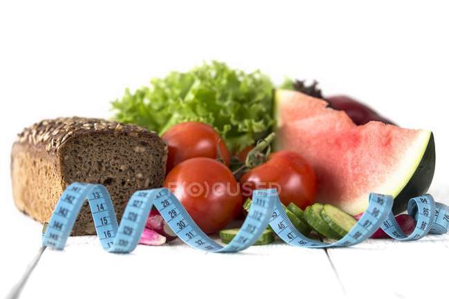 Dieting composition with vegetables, salad, watermelon — Stock Photo