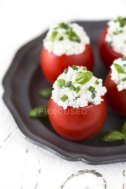 Tomatoes stuffed with cheese — Stock Photo