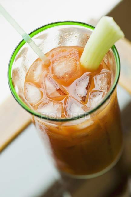 Bloody Mary with celery and ice cubes in glass — Stock Photo