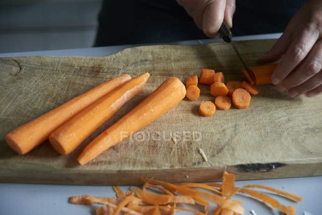 Carrots being sliced — Stock Photo