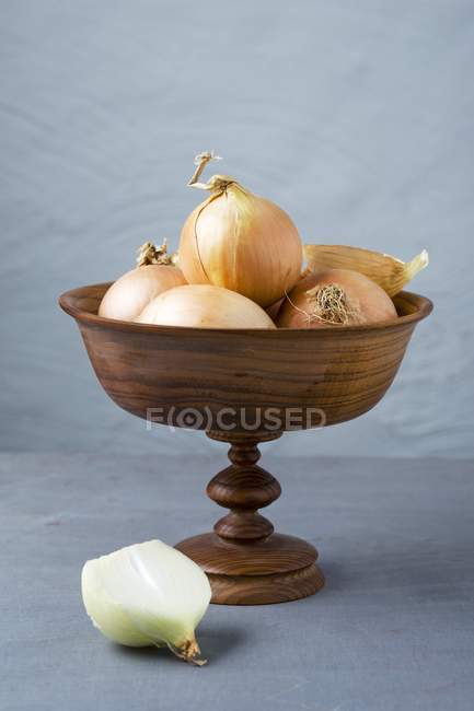Onions in wooden dish — Stock Photo