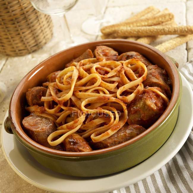 Fettuccine pasta with sausage and marinara sauce — Stock Photo