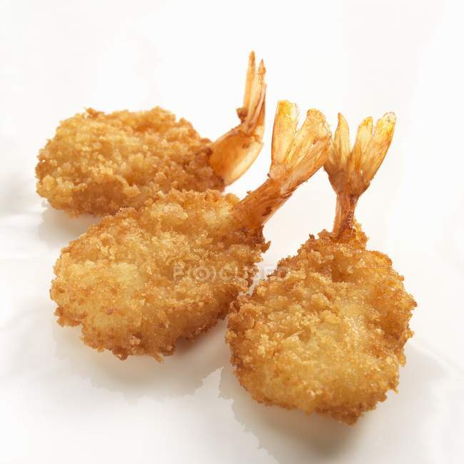 Three breaded fried prawns — Stock Photo