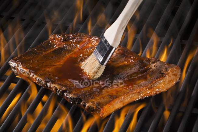 Spare ribs being brushed — Stock Photo