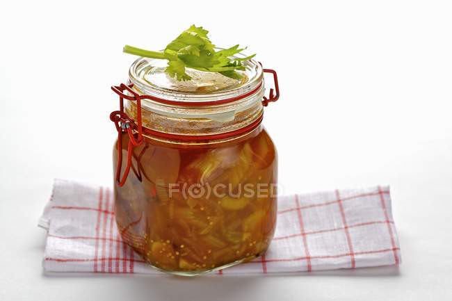 Homemade celery preserve in jar over table — Stock Photo