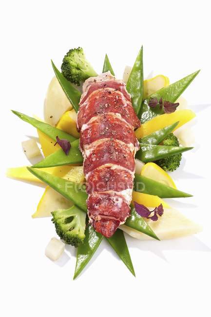 Lobster on mange tout, broccoli and lemons over white background — Stock Photo