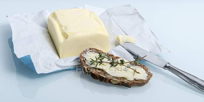 Bread spread with butter — Stock Photo