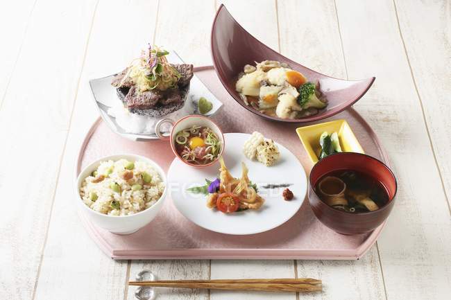 Elevated view of various Japanese lunch dishes on platter — Stock Photo