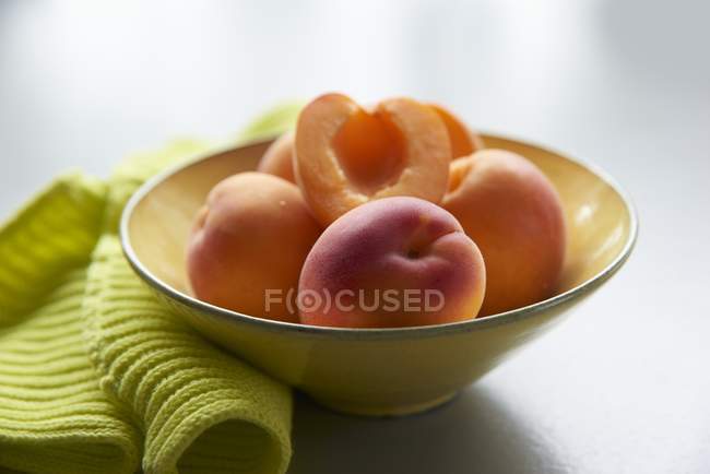 Apricots in yellow bowl — Stock Photo