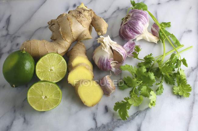 Limes with ginger and coriander — Stock Photo