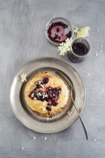 Pancakes with elderberries and fork — Stock Photo
