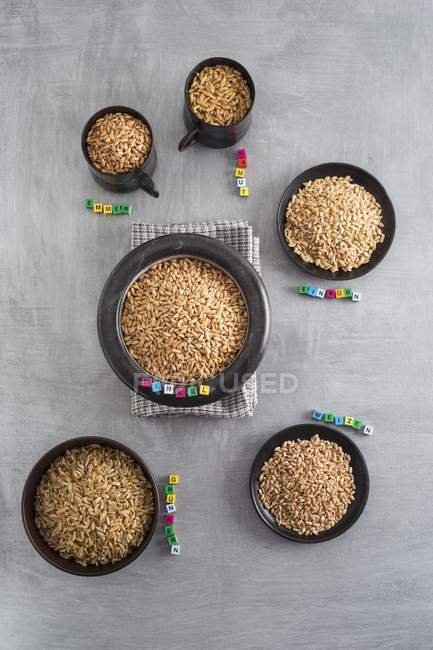 Vari tipi di cereali in tazze e ciotole — Foto stock