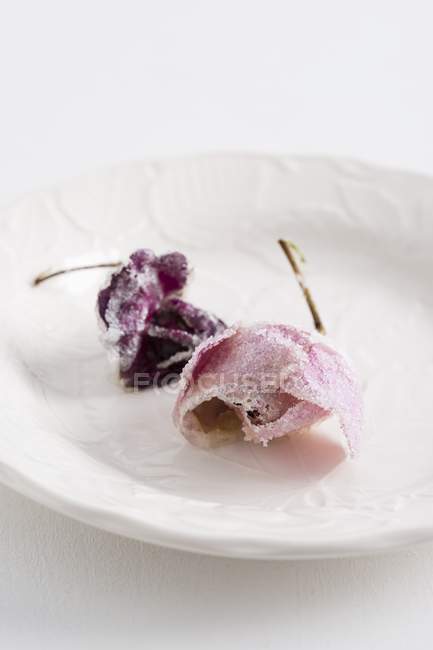 Closeup view of candied roses on white plate — Stock Photo