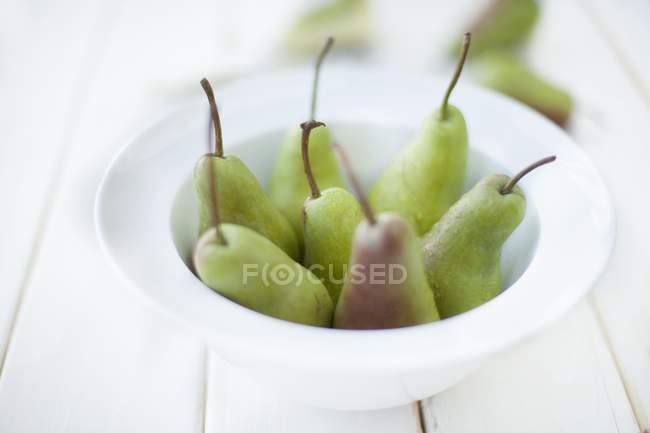 Fresh pears in white bowl — Stock Photo