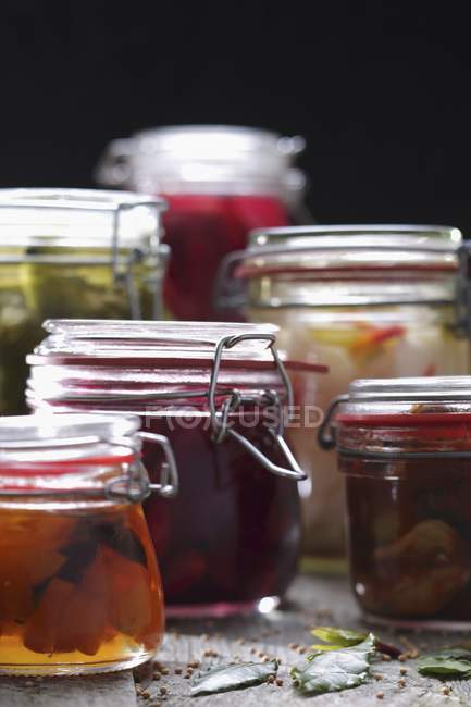Sliced Pickles and Beets in Mason Jars on black background — Stock Photo