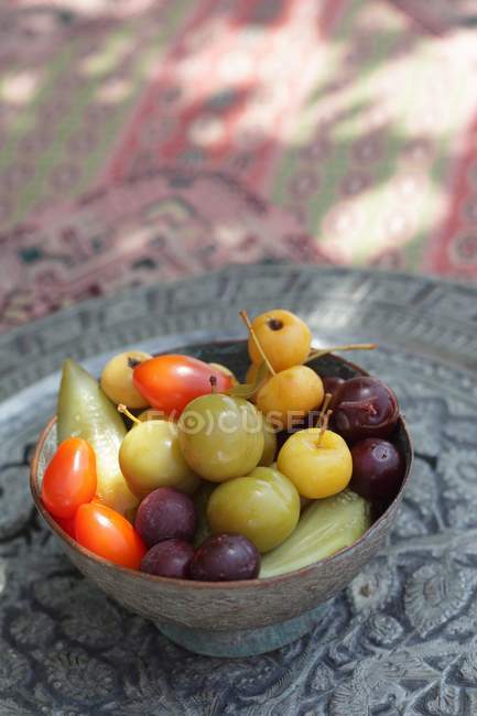 Vista de cerca de coloridas frutas exóticas en un tazón - foto de stock