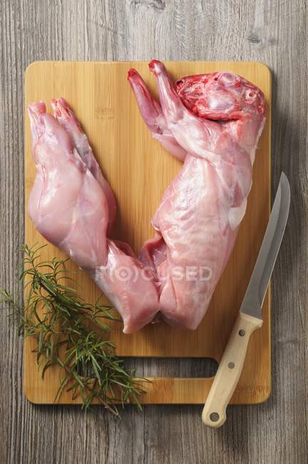 Raw rabbit with rosemary — Stock Photo