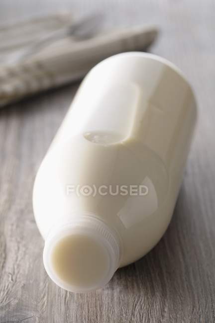 Bottle of milk lying — Stock Photo