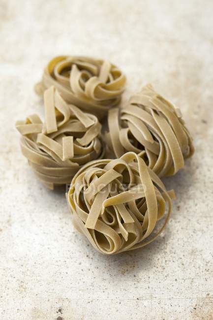 Spinach tagliatelle pasta nests — Stock Photo