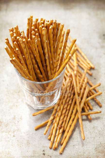 Elevated view of salty sticks in a glass and nearby — Stock Photo