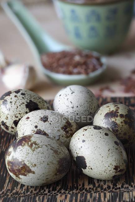 Quails eggs with spoon of red rice — Stock Photo