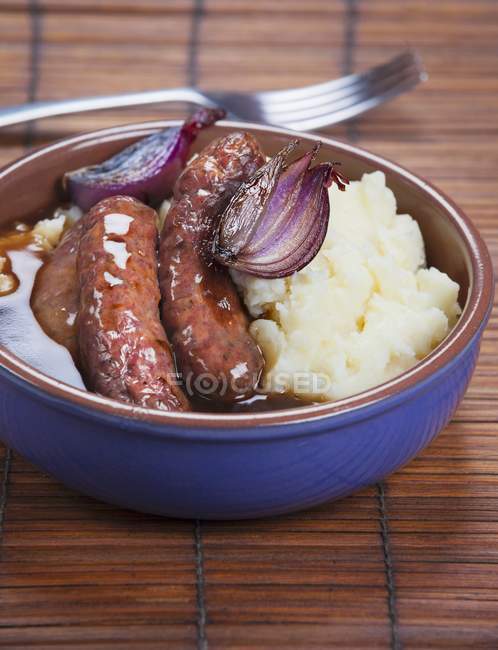 Fried sausages with potatoes — Stock Photo